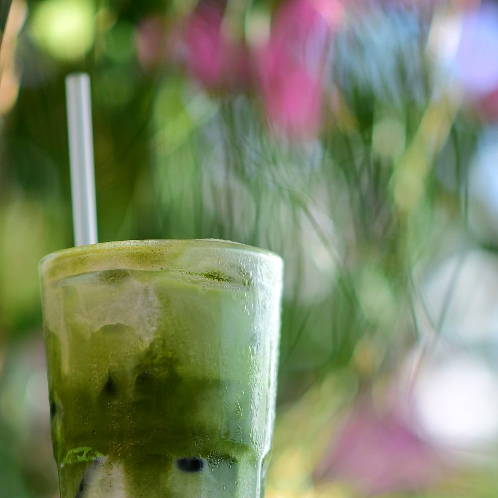 Iced matcha latte in dappled morning light
