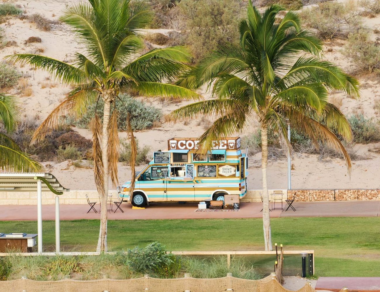 The Nalu mobile coffee van parked by the coast under the trees